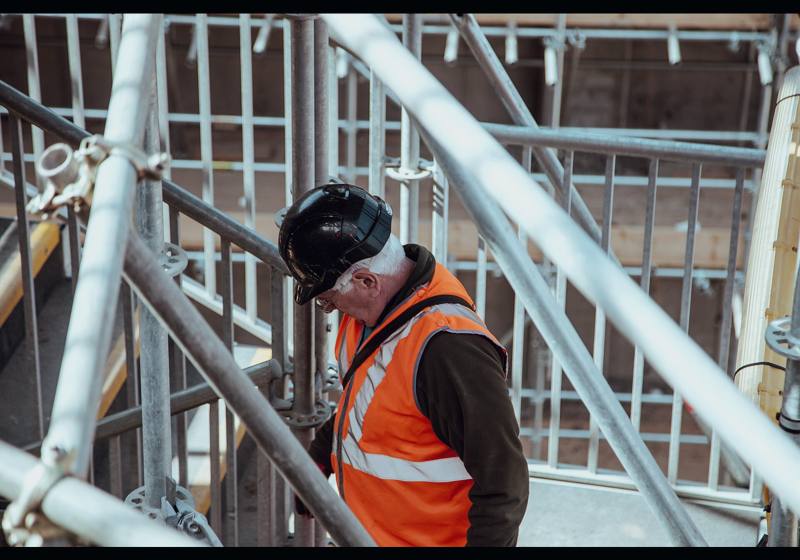 Worker on scaffolding at a building site